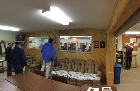 Competitors watch as they wait for their turn to shoot